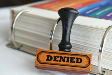 Rubber stamp with word Denied on it. Being turned down rejected refused for a loan or application.