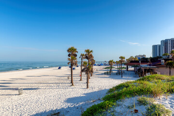 Beautiful Clearwater beach in sunny day with palm trees on white sand in Clearwater, Florida, USA