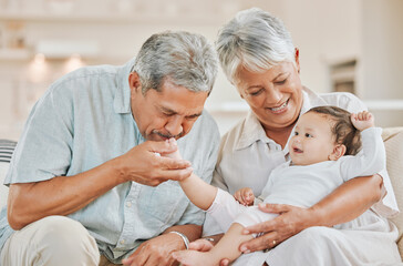 Obraz premium Love, grandparents and baby on sofa in home with kissing, playing and bonding with smile in living room. Happy family, senior people and grandchild in house with care, support and security for visit