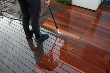 Deck pressure washing with a power washer, wood planks cleaning