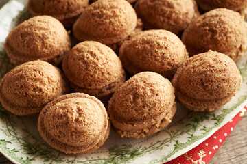 Nut shaped homemade Christmas cookies filled with cream on a plate