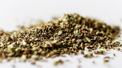 Close-up of a small mountain of dried oregano on a white background