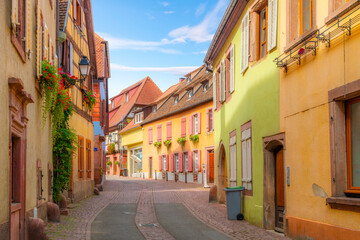 A winding cobblestone street in a residential area of the medieval old town of Ribeauville France, one of the villages of the picturesque Alsace wine region.