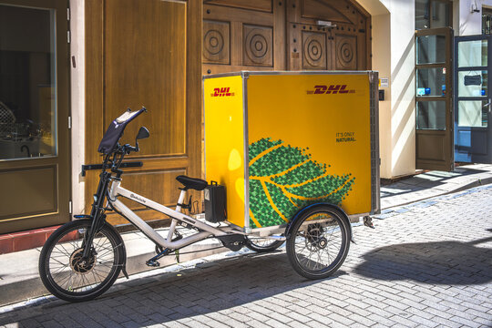Vilnius, Lithuania, August 8, 2024: DHL electric delivery bike in city street. Delivery bicycles for Zero emission last mile delivery