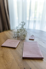 Big pink wallet on a wooden table