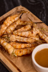 Delicious Grilled Shrimp Accompanied by a Sauce on a Rustic Wooden Platter for Serving