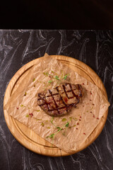 Indulge in a Delicious Grilled Steak Artfully Presented on a Wooden Serving Board