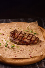 Indulge in a Delicious Grilled Steak Artfully Presented on a Wooden Serving Board