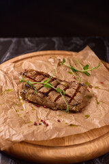 Indulge in a Delicious Grilled Steak Artfully Presented on a Wooden Serving Board