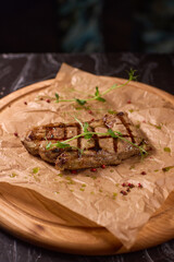 Indulge in a Delicious Grilled Steak Artfully Presented on a Wooden Serving Board