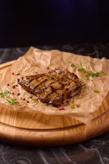 Indulge in a Delicious Grilled Steak Artfully Presented on a Wooden Serving Board