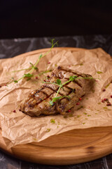 Indulge in a Delicious Grilled Steak Artfully Presented on a Wooden Serving Board