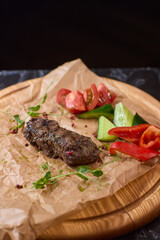 Indulge in a Delicious Grilled Steak Artfully Presented on a Wooden Serving Board