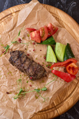 Indulge in a Delicious Grilled Steak Artfully Presented on a Wooden Serving Board