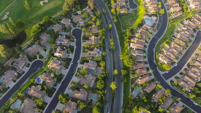 The aerial view of a suburban neighborhood in Calabasas, Los Angeles, reveals wellmaintained homes, lush green areas, and meandering streets fostering a serene sense of community living