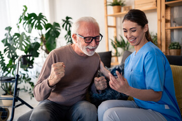 In a cozy apartment, a cheerful female nurse in blue scrubs measures the blood sugar of a jovial elderly man, reflecting competent in-home care services.