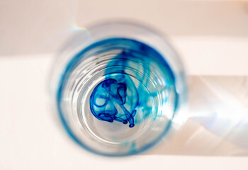 abstract closeup image of methylene blue in a glass of water.