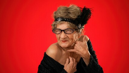 Funny portrait of happy elderly senior woman with no teeth pointing fingers herself ask say call...