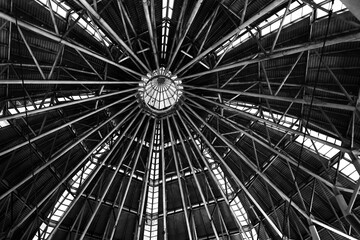 A large metal dome from inside the shopping center building.