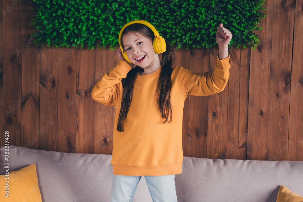 Poster photo portrait of nice little girl headphones listen music dance wear orange clothes modern interior