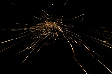 sparks from the grinder glowing in the dark