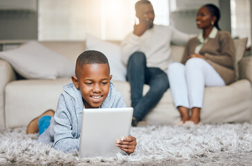 Boy, relax and floor with tablet at house for streaming, education games and watch videos of...