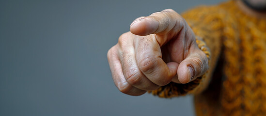 Male hand making gesture of pointing at something.