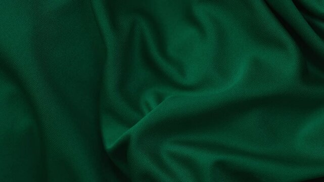 A dark green fabric texture background. Close up.