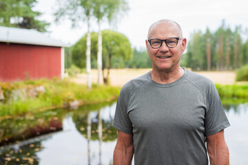 Senior Finnish Man Outdoors in a Scandinavian Forest Summer Portrait in the Woods Finland