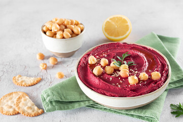 Beetroot hummus with parsley and olive oil in a plate on a gray background, top view. Arabic, Turkish cuisine.