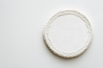 A rounded embroidered patch is displayed against a pristine white surface, showcasing clear, detailed stitches around its edge, emphasizing craftsmanship