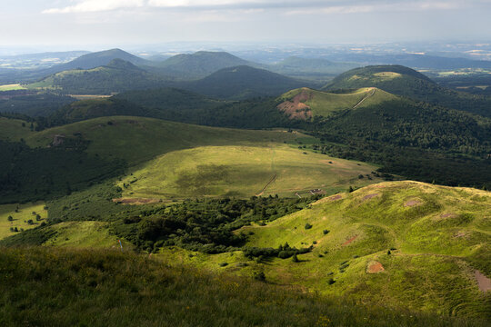 Auvergne vulcan since top of the Puy de Dome vulcan at sunset. Dramatic light landscape. Clermont Ferrand, France.