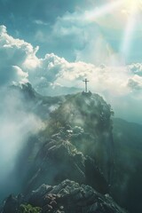 Fototapeta premium A cross sits atop a misty mountain, surrounded by clouds