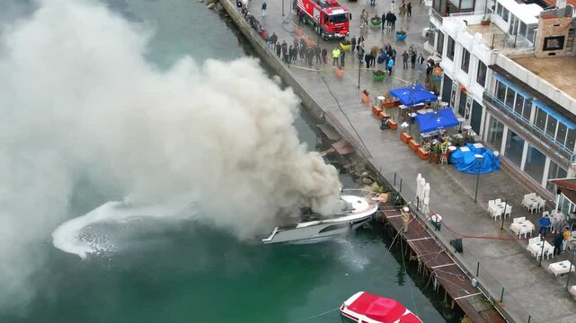 4k Firefighter using Chemical foam fire extinguisher to fighting with the fire flame from boat at pier. Firefighter safety disaster accident and public service concept. 4k video
