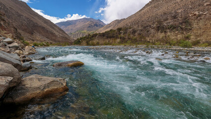 Flowing river with rocky surroundings view