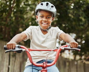 Black child, portrait and riding with bicycle or helmet for fun activity, hobby or outdoor exercise...