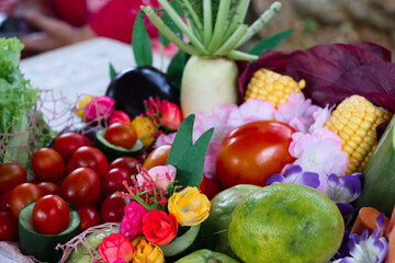 A colorful basket featuring fresh papaya, tomatoes, corn, lime, lettuce, radish, and cherry...