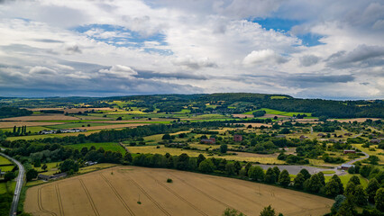 Aerial view of agricultural farmland in rural Wales on a stormy summer day