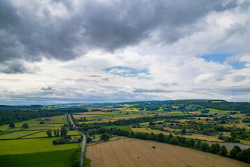 Naklejka premium Aerial view of agricultural farmland in rural Wales on a stormy summer day