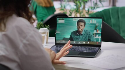 HR recruiter hosting an online interview with job applicant via internet teleconference call, evaluating candidate CV and discussing about career plans. Recruiting on remote videocall. Camera A.