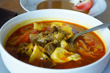 a bowl of tongseng, a spicy Indonesian goat meat soup.