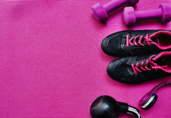 Top view fitness, mat and sneakers for exercise with workout equipment, music and kettlebell in studio. Yoga, dumbbells and training weights with headphones for audio, pilates or wellness with mockup