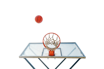A basketball hovers in mid-air approaching a hoop, framed perfectly with a clear backboard.

