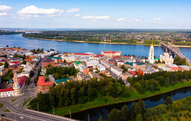 Aerial view of Russian city of Rybinsk in Yaroslavl Oblast overlooking historical area with five-domed Orthodox Transfiguration Cathedral on bank of Volga river and bridge on sunny summer day ..