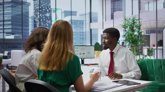 Businessman attending job interview with the HR employees in office, discussing about career plans and the opportunity of human resources development. Recruitment process in enterprise. Camera B.