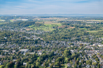 Expansive view of the countryside near Drachenfels, blending rural and suburban landscapes under a clear sky.