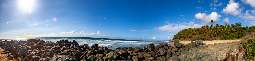 Rinc&oacute;n Beach in Puerto Rico, a heavenly tropical paradise with crystal-clear waters, sandy shores, and lush coastal vegetation, and picturesque Atlantic Ocean shoreline.
