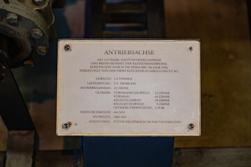 Close-up of an informational plaque detailing the specifications of the mechanical axle at the...