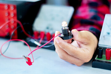 The study electrical circuit systems of students by experimenting with electrical connections using...