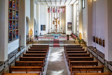 View of the main altar inside Klosterkirche Heisterbach, featuring stained glass windows and...
